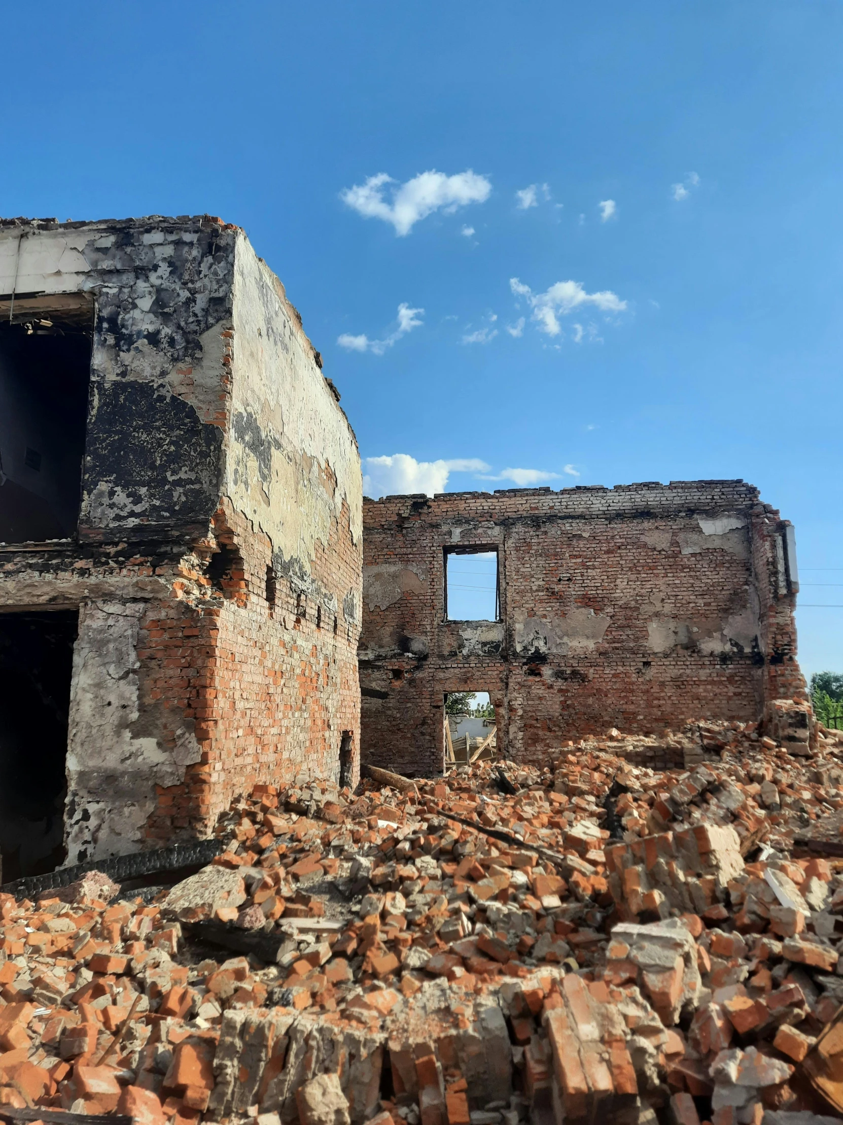 an old stone building with broken windows and no door