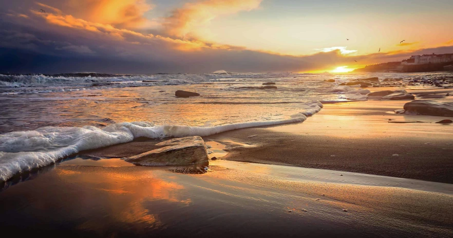 a body of water sitting on top of a sandy beach