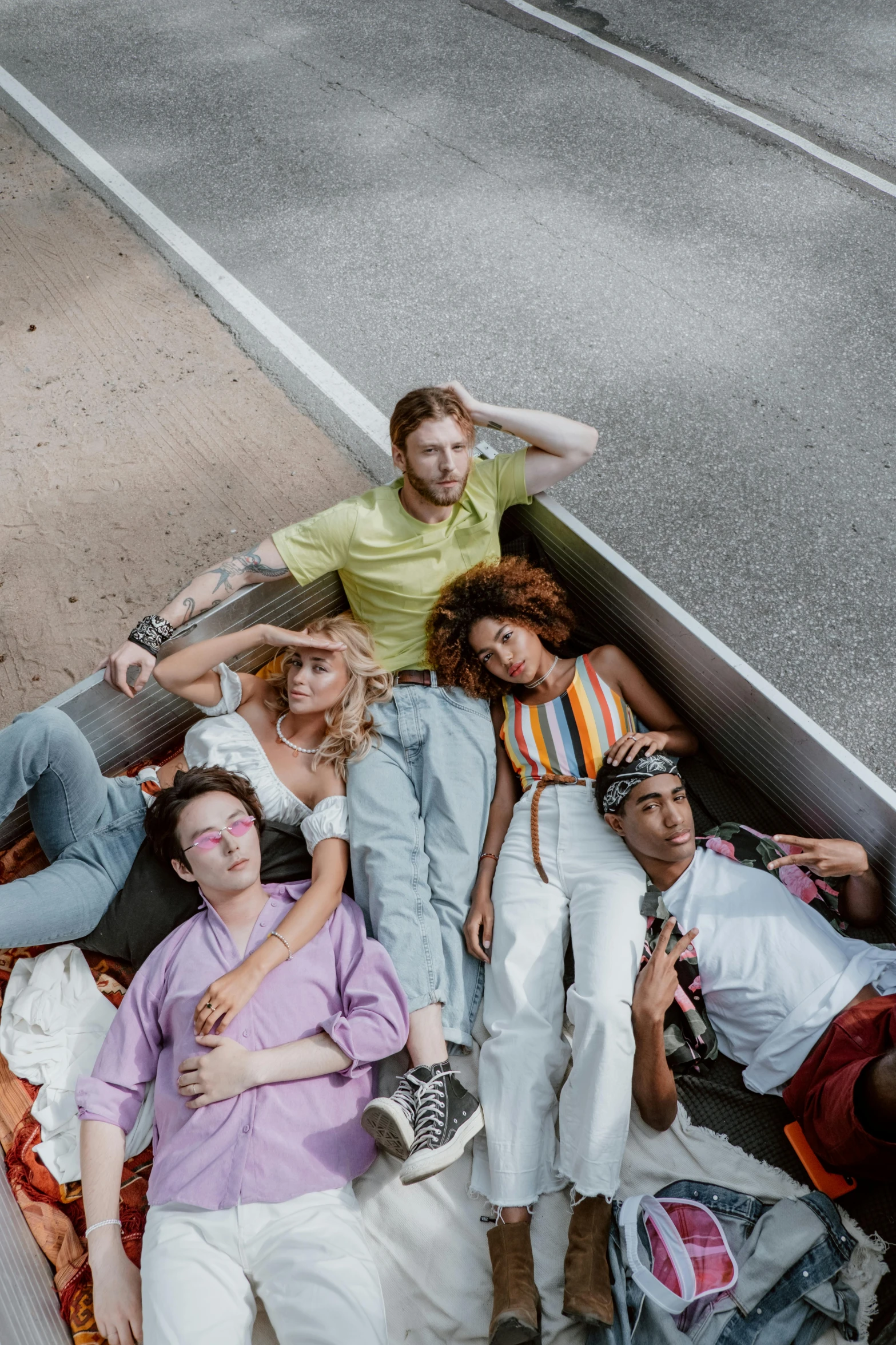 a group of people laying on top of a pile of luggage