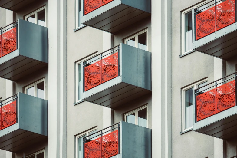 a building with multiple balconies and a clock on each of them