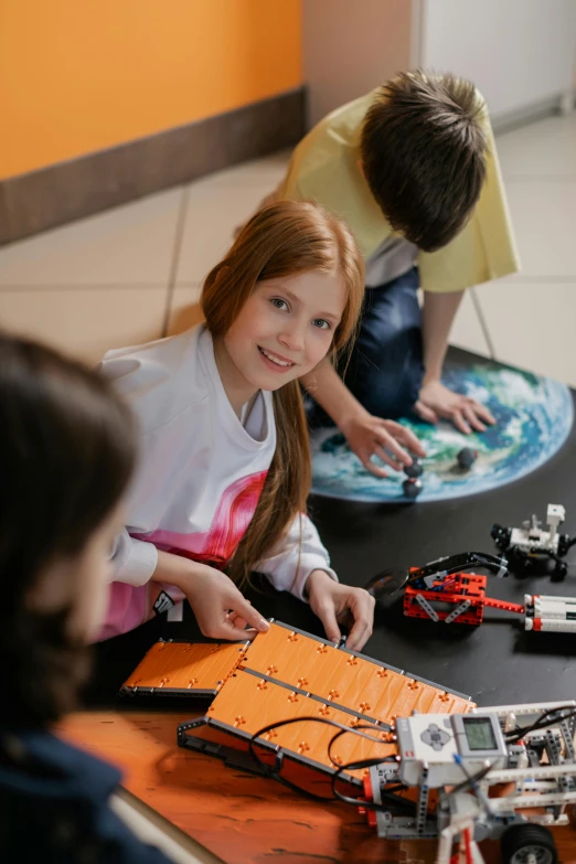 two young s are playing with legos on a table