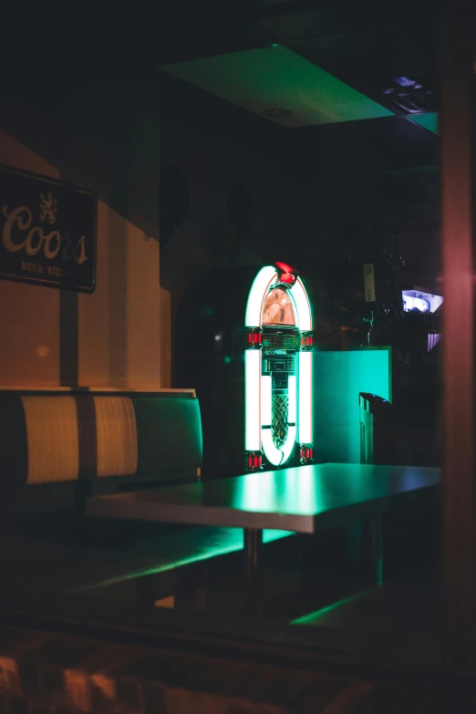 a lit up table with a lighted coke machine