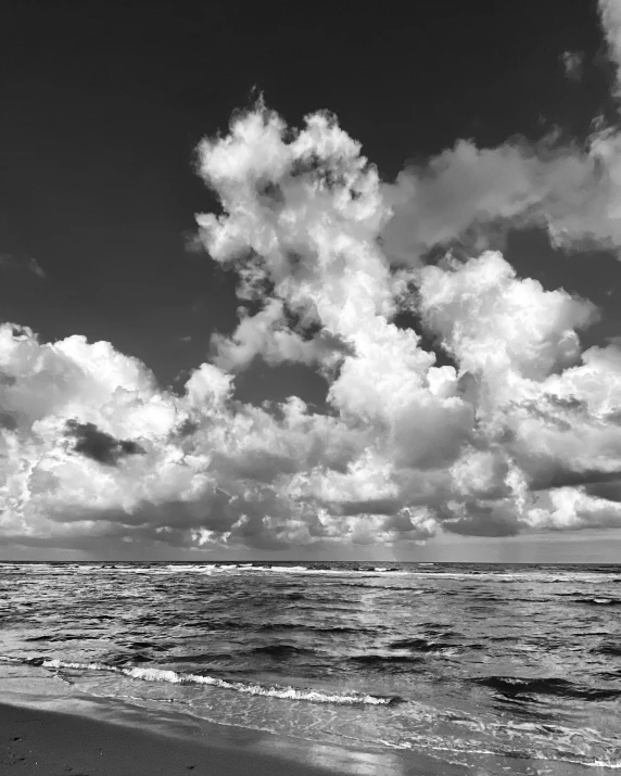 the person is walking on the beach toward the water