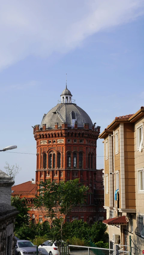 a view of a old red brick building in the middle of the day