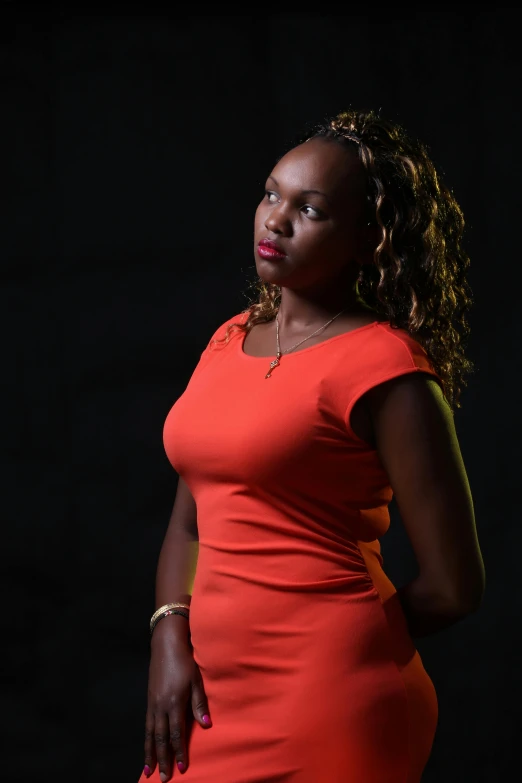 a woman in an orange dress and diamond necklaces