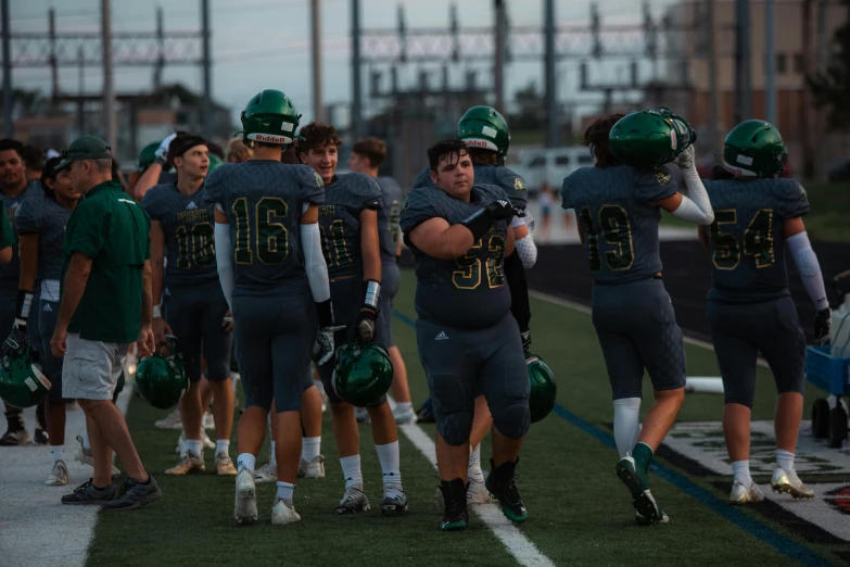 a team walking onto the field in a huddle