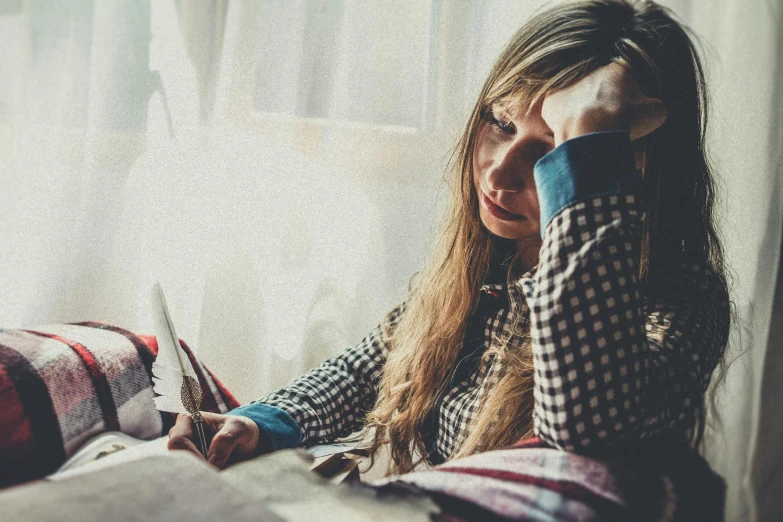 a girl holding a pair of scissors while looking at soing