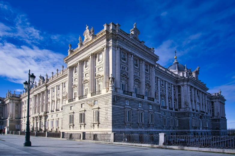 the facade of a large old building with some light towers