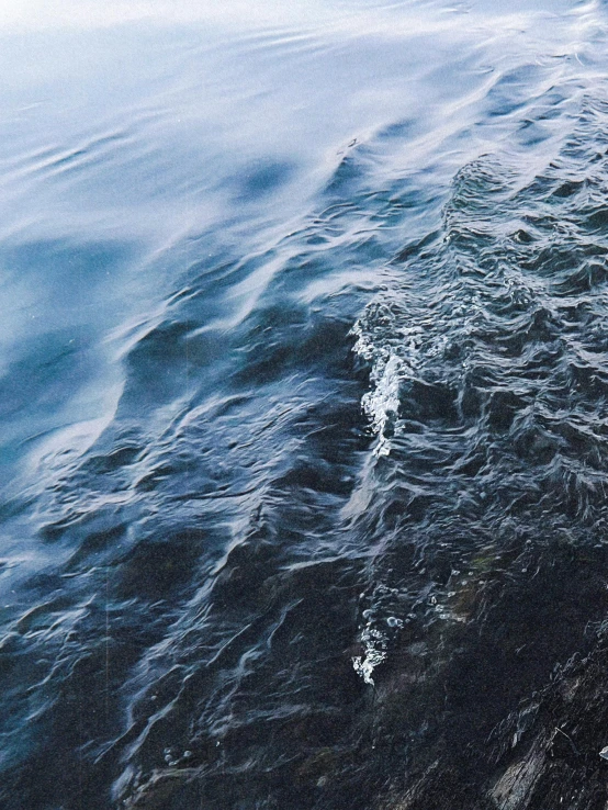 the ocean with very dark water with an empty patch of land