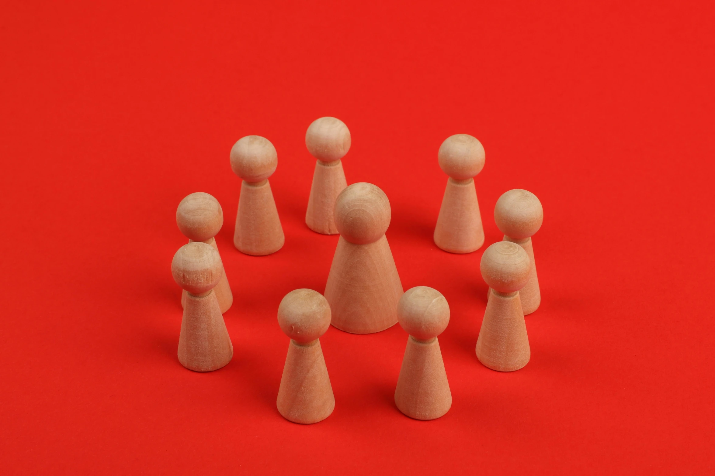 a few wooden toys on a red background