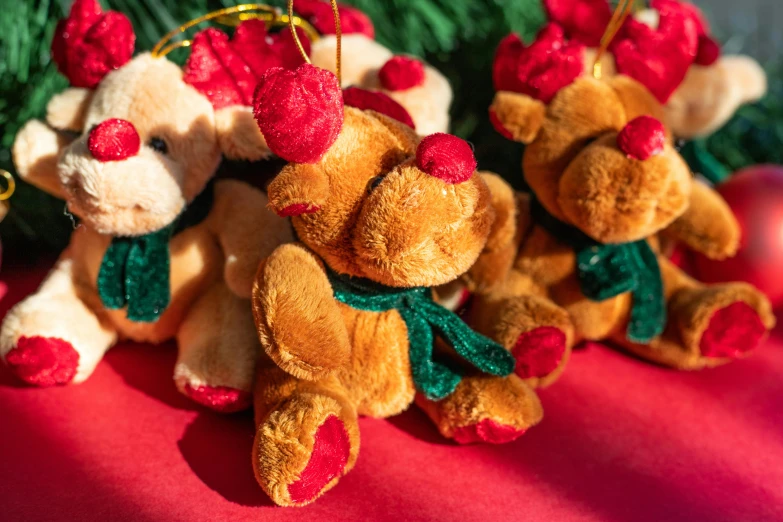a group of stuffed teddy bears wearing bows and ornaments