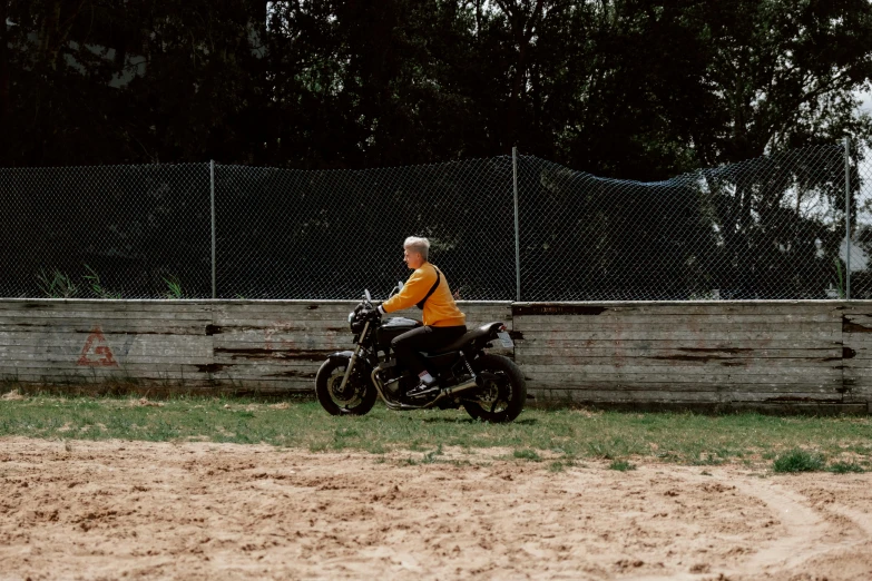 a person in yellow sitting on a motorcycle