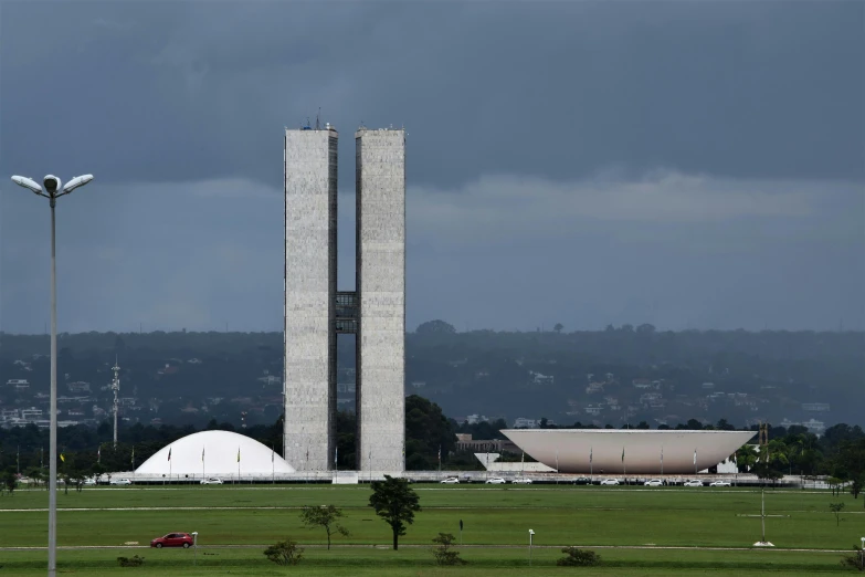 a tall tall building on top of a lush green field