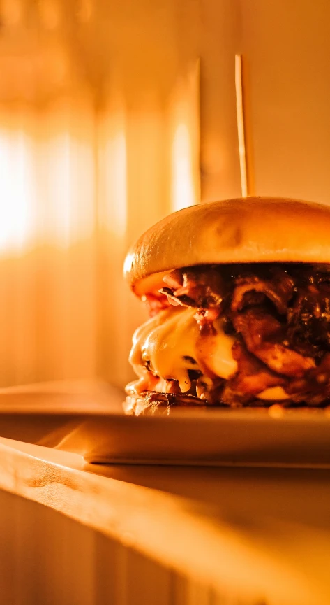 a big cheeseburger that is sitting on a table