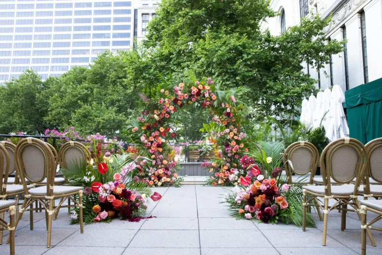 an outdoor garden with chairs and flowers