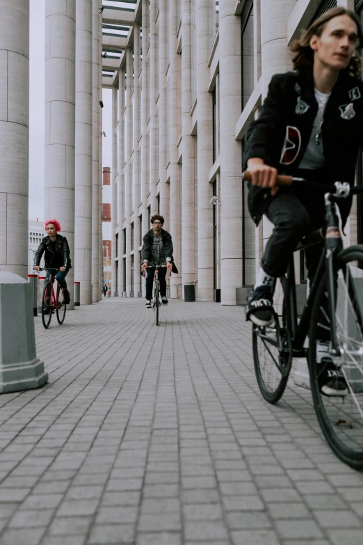 bicyclist, bike and pedestrian passing down a city street