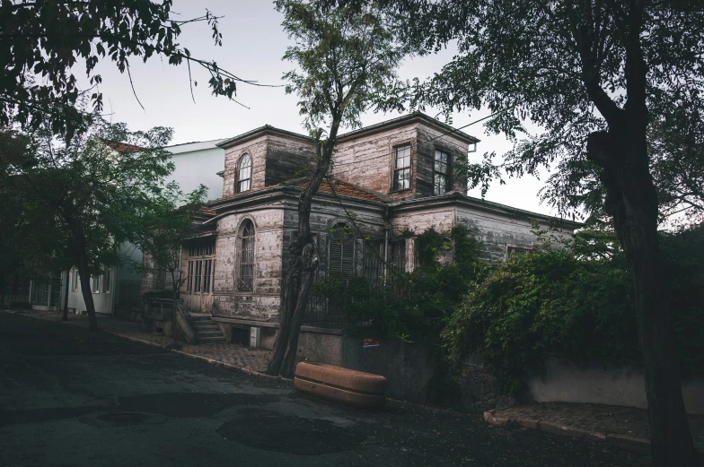 a stone house with a large tree in front of it