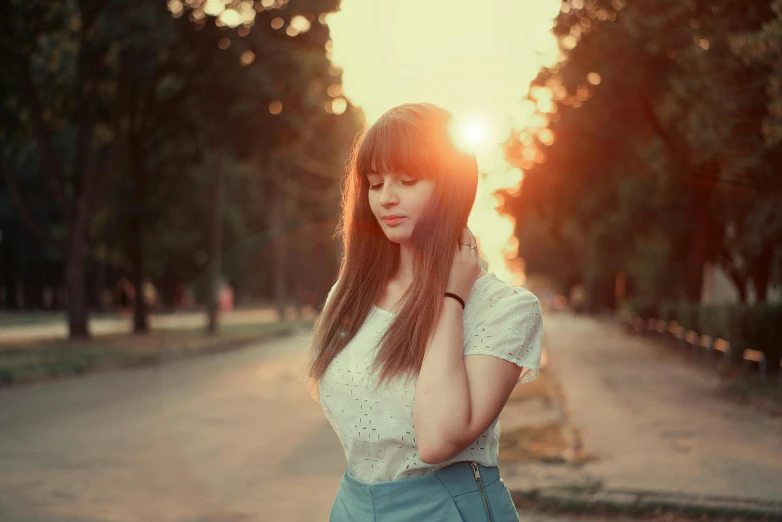 the girl is posing with her hand on her head