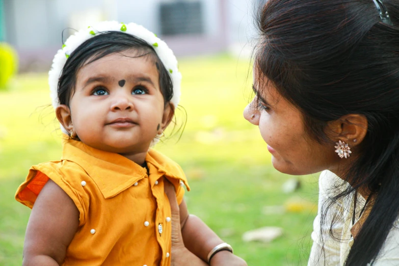 a woman is holding the back of a baby