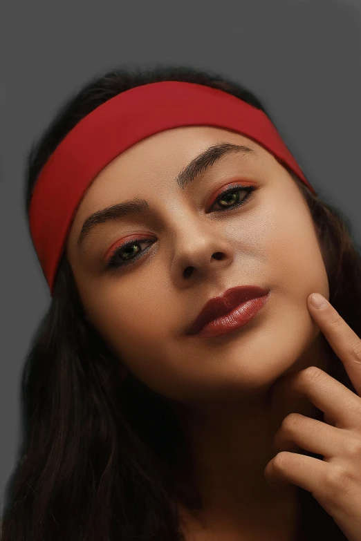 a woman is wearing a head band and red lipstick