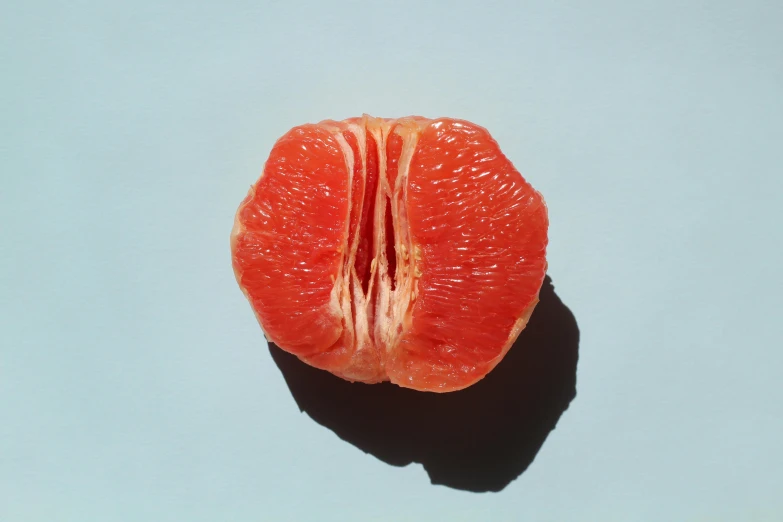 a piece of fruit cut in half with one bite out
