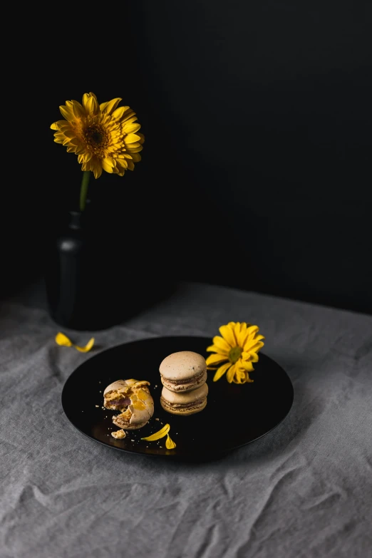 a small plate is set on a bed with a flower in front of it