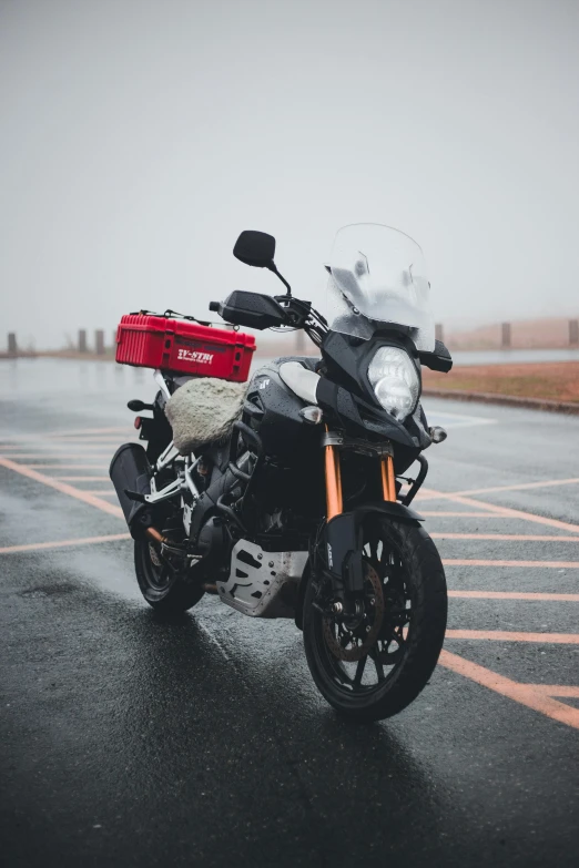 a parked motorcycle on a wet parking lot