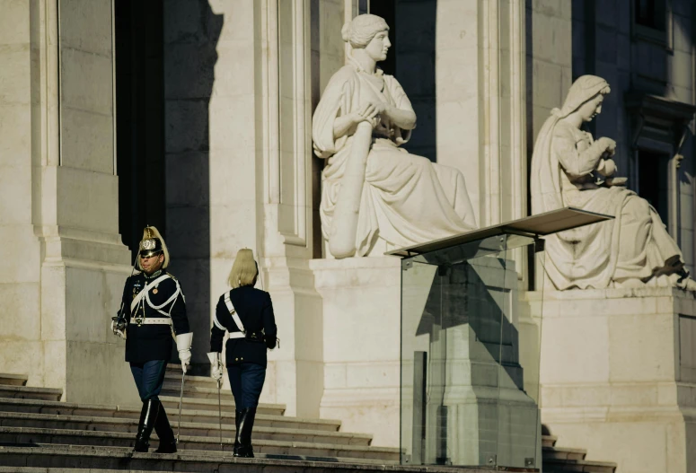 the guards are walking towards the statue