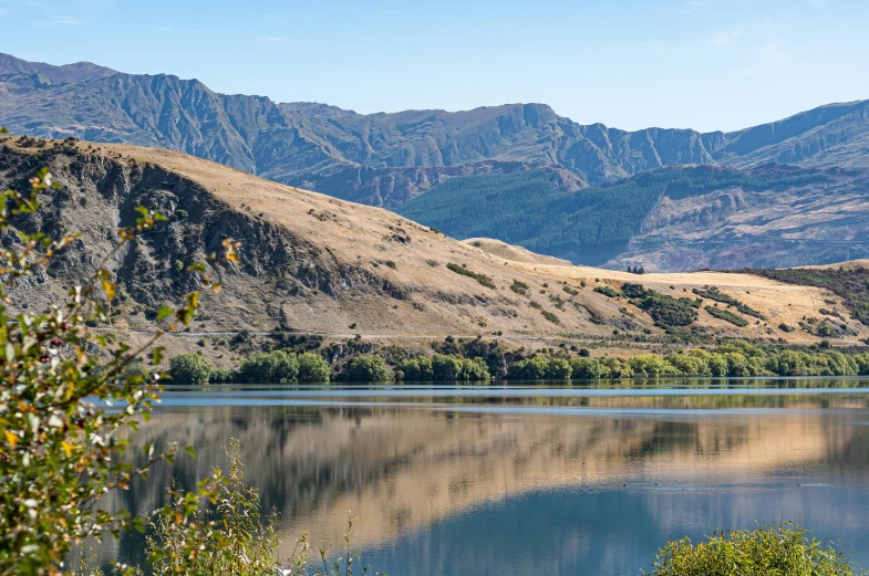 the mountain range reflected in the clear water