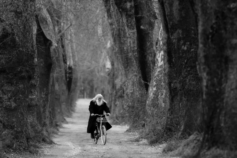 a woman on a bike is riding down the road