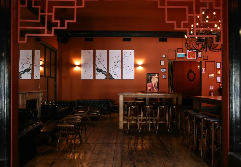 a restaurant with a table, chairs and chandelier