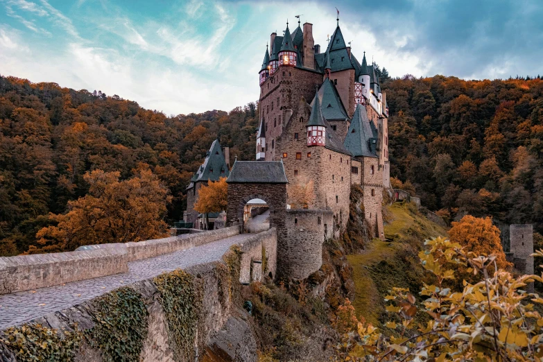 a very tall castle perched on the side of a cliff