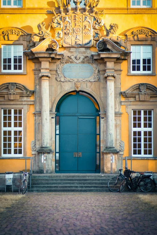 two bikes are parked against a door outside a building