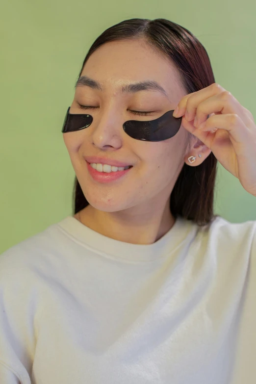 the young woman with a blindfold is smiling