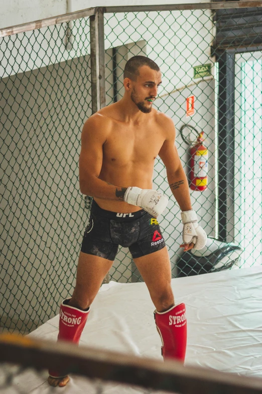 a man with white gloves and boxing gloves is holding his mitt