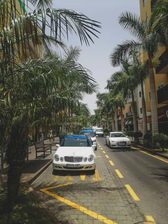 a view down the street with a car parked in the distance