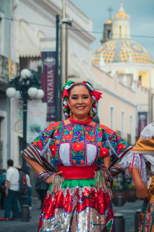 a woman dressed in some kind of colorful dress