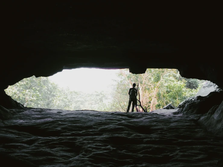 someone taking a picture of a tunnel in the ground