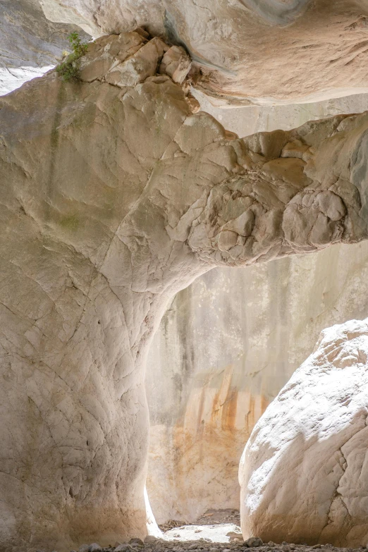 there is a stone cave and a small stream in the distance