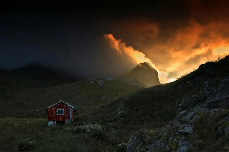 the sky over some mountain tops has a red cabin in the grass