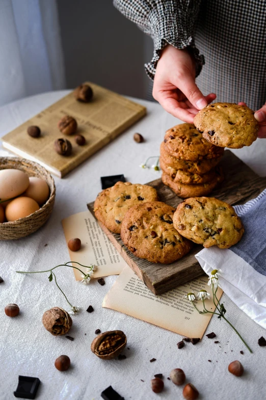 chocolate chip cookies being dunked together by someone