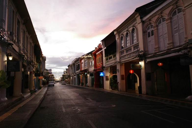 a street scene with a few buildings in the distance