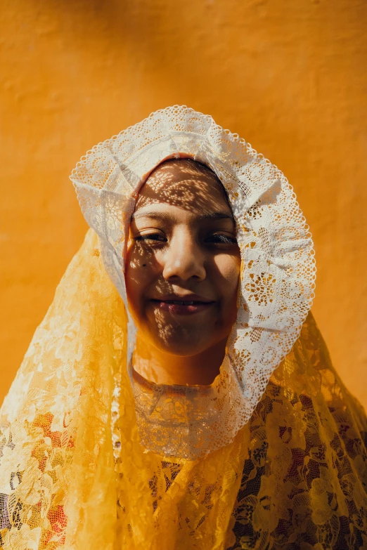 a woman in a white bonnet with yellow lace on her head