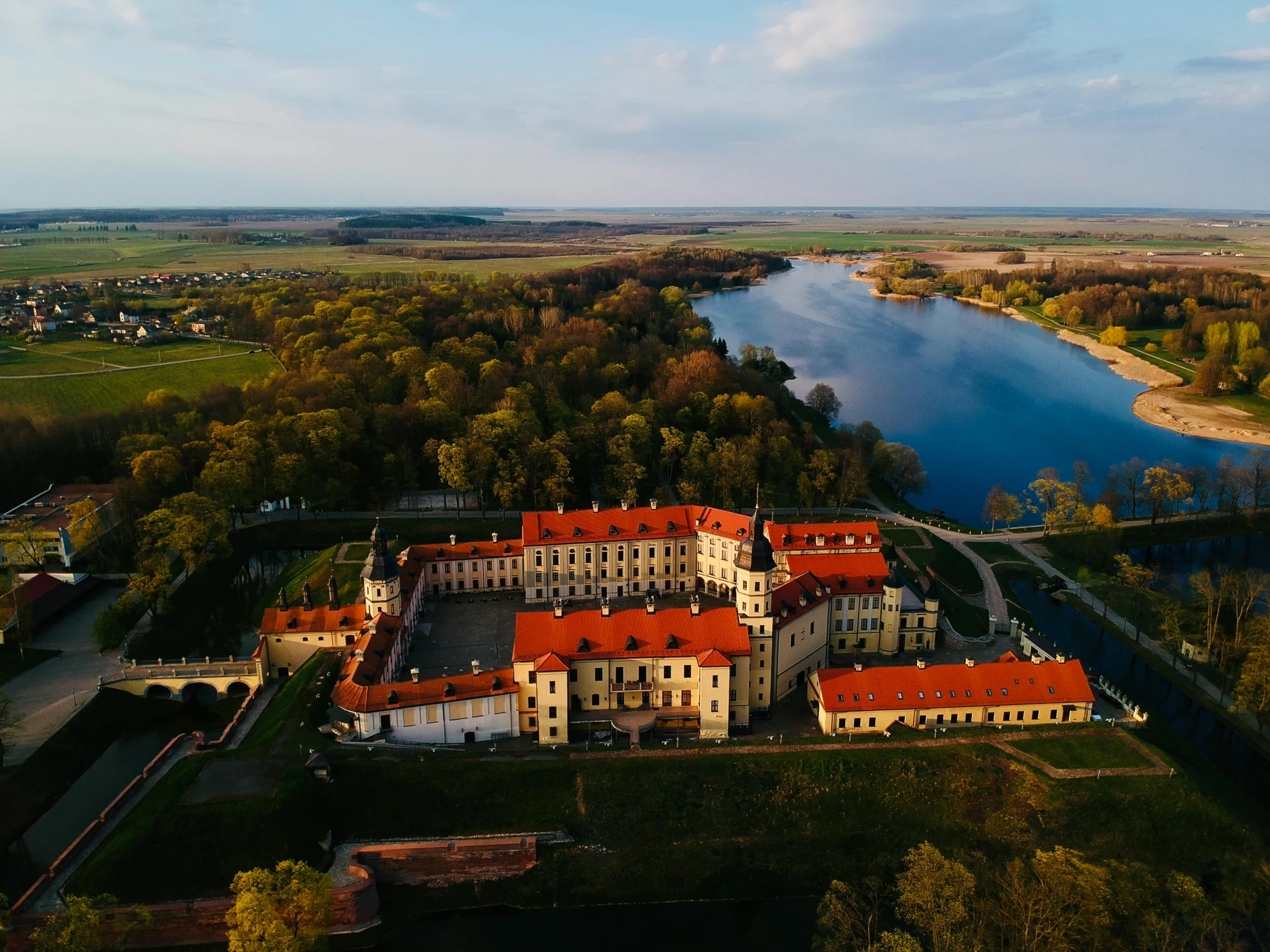 a large estate on a river side next to a small lake