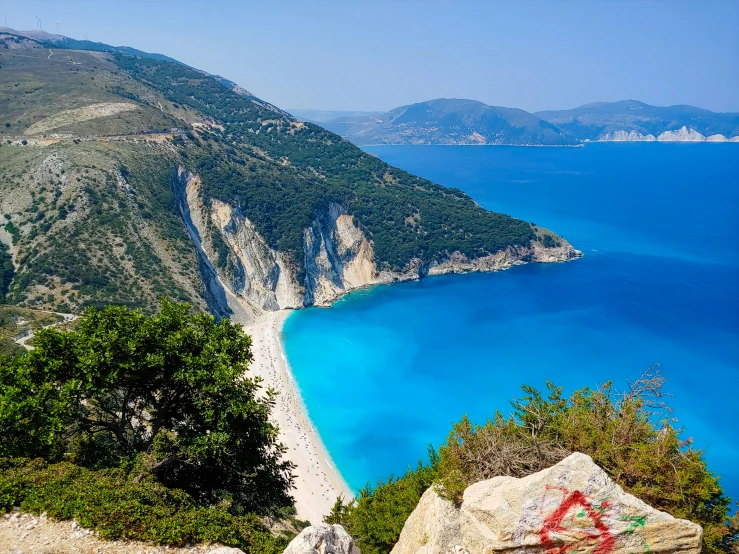 a person standing on a cliff overlooking the ocean