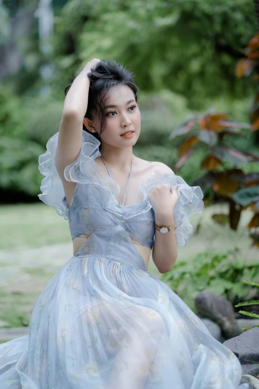 a beautiful asian girl in a dress posing