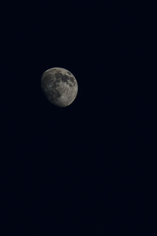 the moon seen from a distance in the sky