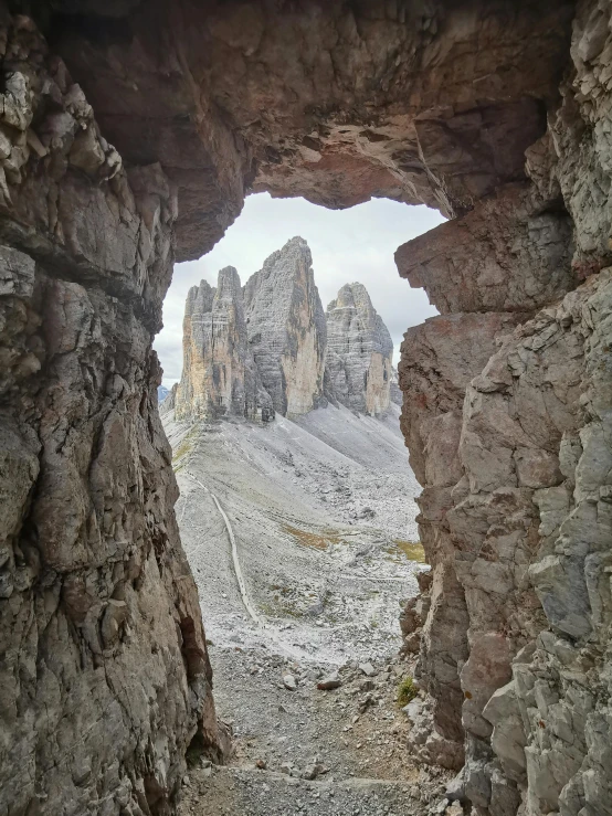 the view from behind an archway on a rocky terrain