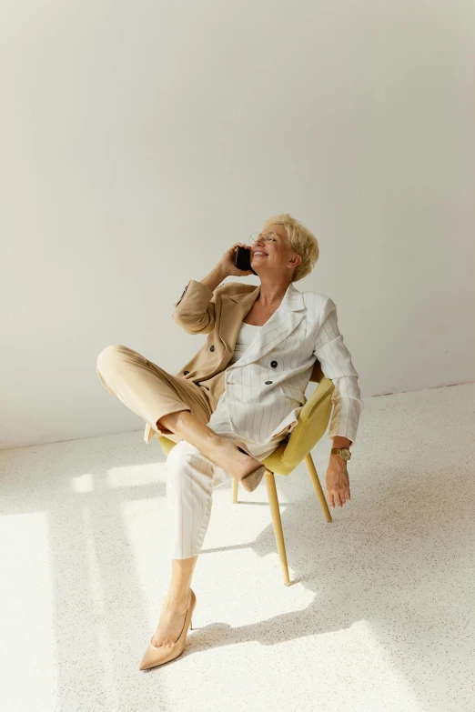 an older woman sitting on a chair in a room