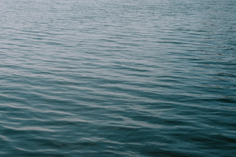 a lone boat floating on top of a body of water